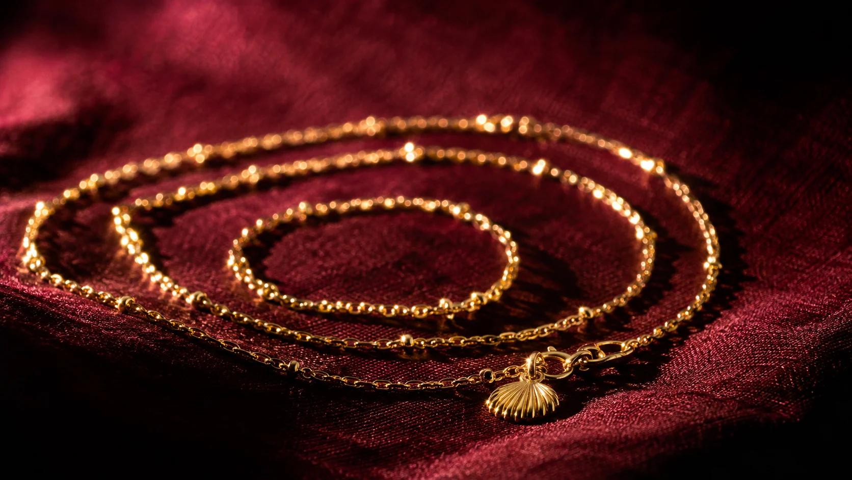 Gold chain coiled on deep red silk